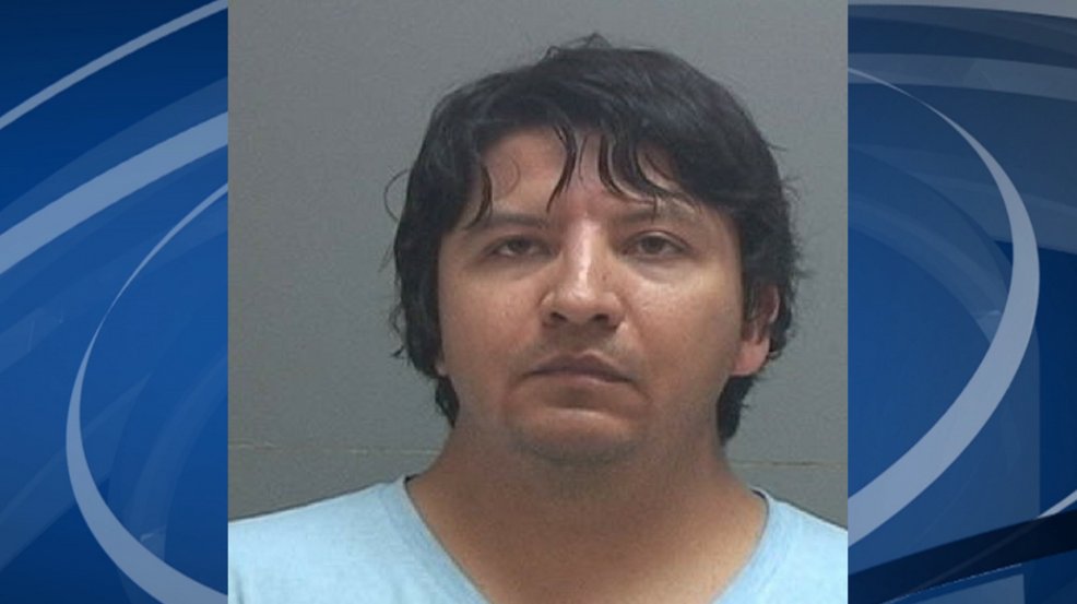 A man was arrested for allegedly spying on an underage girl in a changing room stall 