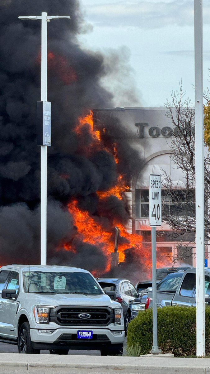 Tooele 1000 N Main St. A semi dump truck possibly lost his brakes and has crashed into multiple vehicles. It continued and crashed into a Dealership where it exploded and has caught multiple vehicles on fire. 